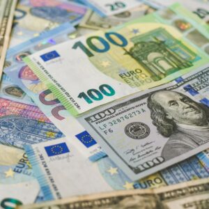 A detailed image of Euro and US dollar banknotes scattered, symbolizing global currency exchange.